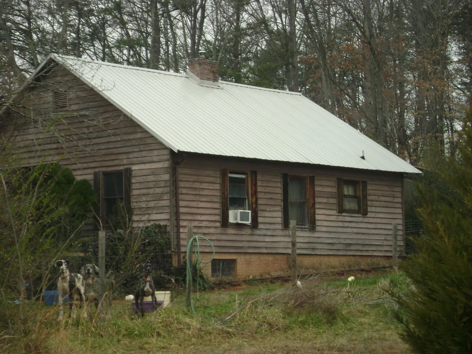 White metal roof on an old wood sided farmhouse, from a Metal Roof Installation job in Newaygo